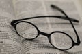 Black frame glasses are placed on the Chinese-English Bible Royalty Free Stock Photo