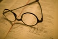 Black frame glasses are placed on the Chinese-English Bible Royalty Free Stock Photo