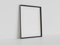 Black frame leaning on white floor in interior mockup. Template of a picture framed on a wall 3D rendering Royalty Free Stock Photo