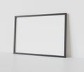 Black frame leaning on white floor in interior mockup. Template of a picture framed on a wall 3D rendering Royalty Free Stock Photo