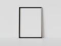 Black frame leaning on white floor in interior mockup. Template of a picture framed on a wall 3D rendering Royalty Free Stock Photo