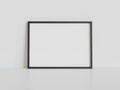 Black frame leaning on white floor in interior mockup. Template of a picture framed on a wall 3D rendering Royalty Free Stock Photo