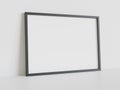 Black frame leaning on white floor in interior mockup. Template of a picture framed on a wall 3D rendering Royalty Free Stock Photo