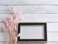 Black frame mockup with grass flowers
