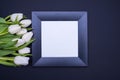 Black frame with white background and a bouquet of white tulips on the left side Royalty Free Stock Photo