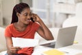 Black Freelancer Lady Talking On Cellphone And Working With Documents At Home Royalty Free Stock Photo