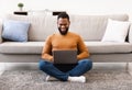 Black Freelancer Man Using Laptop Sitting On Floor At Home Royalty Free Stock Photo