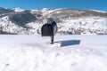 Black freestanding residential mailbox against deep snow in Park City Utah