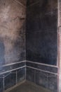 Black fresco on the wall in villa of the mysteries in Pompeii (Pompei Royalty Free Stock Photo