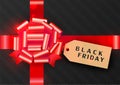 Black Friday banner. Gift box black decorated with red bow and label tag. Top view. Design luxury and premium. Royalty Free Stock Photo