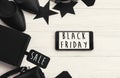 Black Friday big sale text on phone screen. Special discount christmas offer. Phone with advertising message at gift boxes and pr Royalty Free Stock Photo