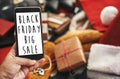 Black Friday big sale text on phone screen. Special discount christmas offer sign. Big Sales. Hand holding phone with advertising Royalty Free Stock Photo