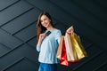 Black friday concept, cheerful woman holding payment card and shopping bags in her hands Royalty Free Stock Photo