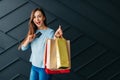 Black friday concept, cheerful woman holding payment card and shopping bags in her hands Royalty Free Stock Photo