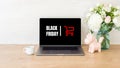 Black friday concept. Laptop computer screen with shopping card and sign Royalty Free Stock Photo