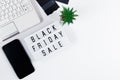 Black Friday concept. Laptop and mobile phone on white background. Online sale and discount Royalty Free Stock Photo