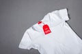 Black Friday Concept. Mock-up Tag White T-shirt on Grey Background Royalty Free Stock Photo