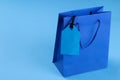 Black Friday. The concept of shopping. sale. Shopping bag and price tag sale on a blue background Royalty Free Stock Photo