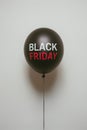 Black Friday Concept with Single Red Text on a Dark Balloon Against Neutral Background Royalty Free Stock Photo