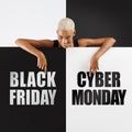 Black Friday And cyber Monday shopping. Smiling black woman pointing at a text on advertising banner commercial sign. Store and Royalty Free Stock Photo