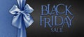 Black friday gift card with shiny blue ribbon bow isolated on glittering black background template with black friday sale written