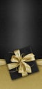 Black Friday gift package wrapped with golden ribbon bow isolated on black background, template for promotional card with copy