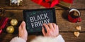 Composite image of black friday with green christmas icons