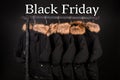 Black Friday. A lot of coats, jacket with fur on hood hanging clothes rack.