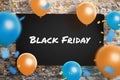 Black Friday poster on wall surrounded with ballons and confetty Royalty Free Stock Photo