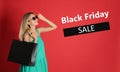 Black Friday Sale. Beautiful young woman with shopping bags on red background