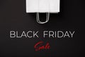 Black Friday Sale. Blank white paper bag isolated on black background. Black friday, sale, discount, recycling, shopping