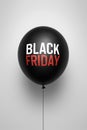 Black Friday Sale Concept with a Single Dark Balloon on a Plain Background Royalty Free Stock Photo