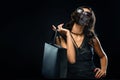 Black friday sale concept in 2020 - time of coronavirus pandemic. Shopping woman in medical mask holding grey bag Royalty Free Stock Photo