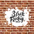 Black Friday sale handwriting lettering on brick wall with paint spot