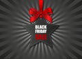 Black friday sale poster. star-shaped price tag with red bow on black sunburst background Royalty Free Stock Photo