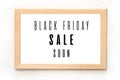 Black Friday sale poster in wooden frame hanging on the wall. Vector illustration Royalty Free Stock Photo