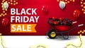 Black Friday sale, red discount banner with wheelbarrow with presents to black friday near the wall, balloons in the air Royalty Free Stock Photo