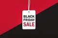 Black friday.Sale tag with text and the rope hanging on red and black background Royalty Free Stock Photo