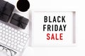 Black Friday Sale text on white picture frame with keyboard mouse coffee cup, gift box and on white background. Shopping concept Royalty Free Stock Photo