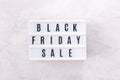 Black friday sale word written on lightbox on light background