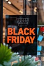 A black friday sign in a store window with shopping carts, AI Royalty Free Stock Photo