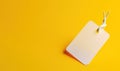 Black Friday. White price tag sticker on a string on a yellow background. AI generated Royalty Free Stock Photo