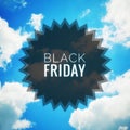 Black Friday word on blue sky and clouds background. Royalty Free Stock Photo