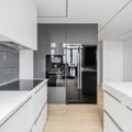 Black fridge in white kitchen