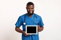 Black friendly doctor demonstrating empty digital tablet screen