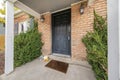 Black front door entrance of a house with lockbox and holloween decorations