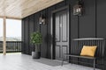 Black front door of black house, bench, side view Royalty Free Stock Photo