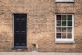 Black front door on a restored brick wall of a Victorian house r Royalty Free Stock Photo