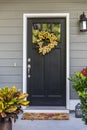 A black front door to a townhouse, apartment or condominium