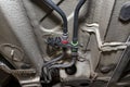 Black fuel lines mounted under the cars chassis, view from the bottom of the car on a jack in a car workshop. Royalty Free Stock Photo